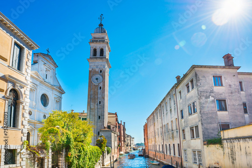 View of campanile of church San Giorgio dei Greci and canal on a sunny day. Venice, Italy