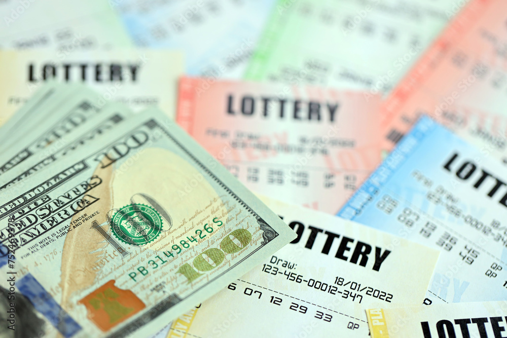 Many lottery tickets and dollar bills on blank bills with numbers for playing lottery close up Many lottery tickets and dollar bills on blank bills with numbers for playing lottery close up