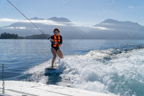 Obraz na płótnie Woman in her 30s learning wake boarding in the lake. w salonie