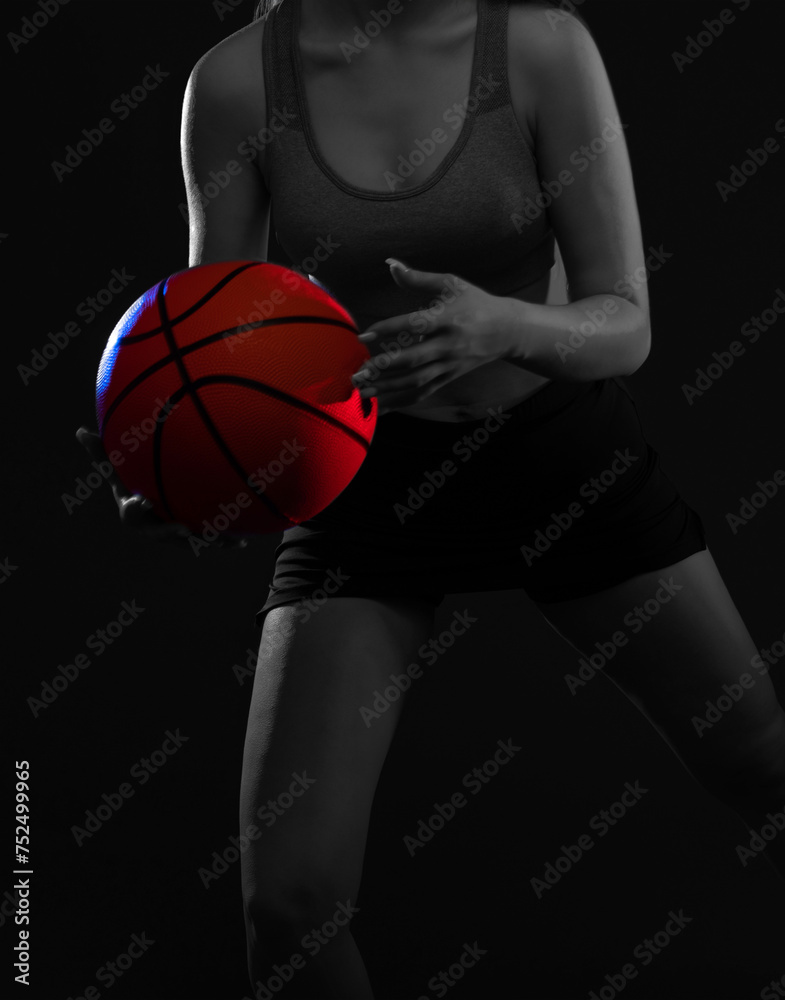 A beautiful slender girl athlete in shorts and a top plays basketball. A beautiful slender girl athlete in shorts and a top plays basketball.