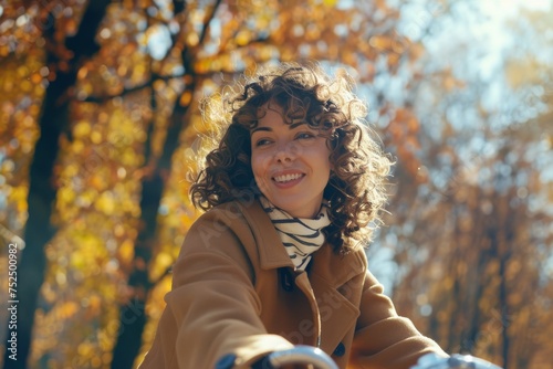 Joyful woman enjoying autumn vibe during an outdoor ride