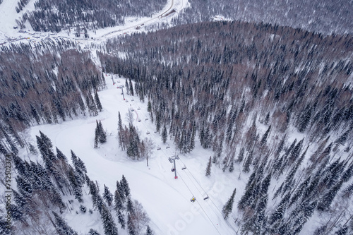 Aerial top view ski lift resort in winter, landscape with forest, Sheregesh Kemerovo region Russia