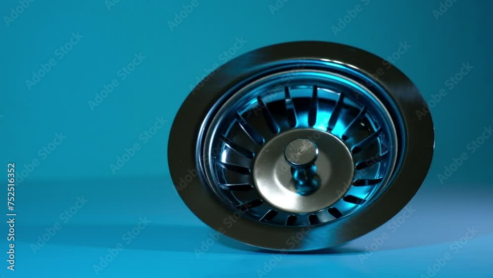 drain of a washbasin with strainer on blue background drain of a washbasin with strainer on blue background