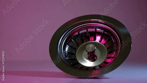 
drain of a washbasin with strainer on red background