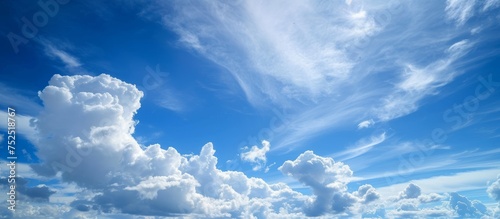 Majestic large fluffy cloud formation in vibrant blue sky background photo