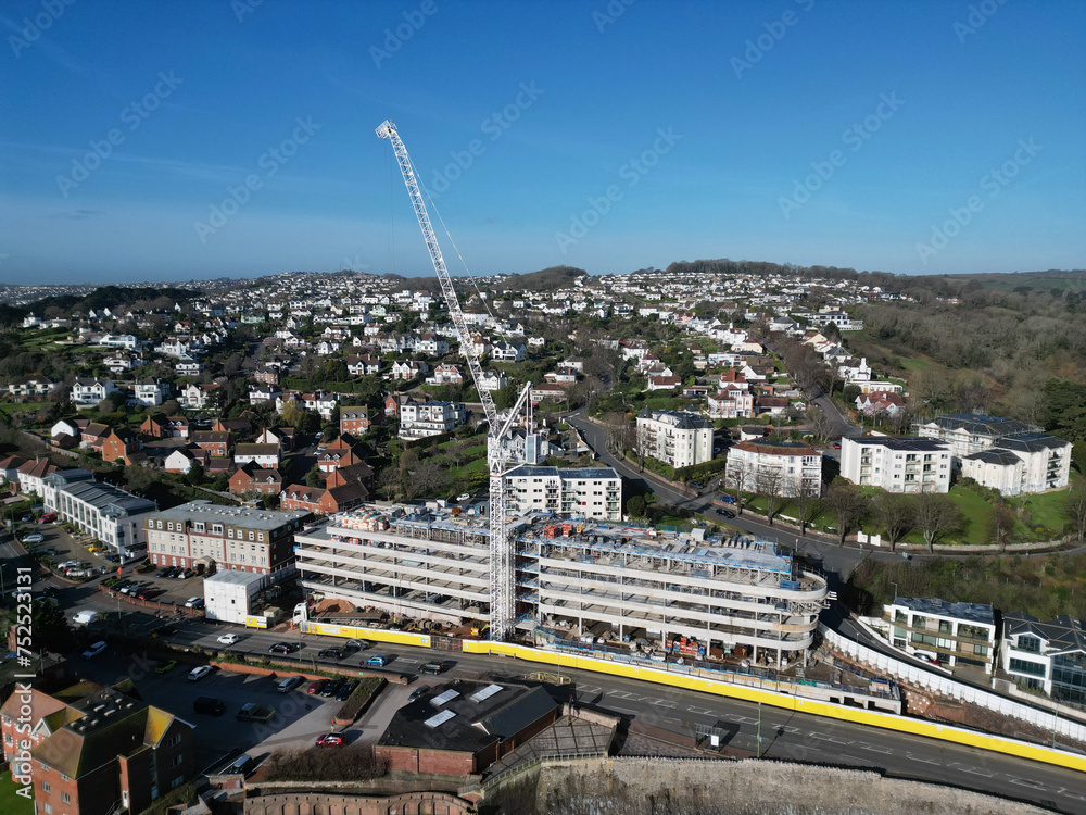 Torquay, Torbay, South Devon, England: DRONE VIEWS: The drone circles a new hotel construction site and its crane, close to the seafront. Torquay is a popular UK holiday resort.