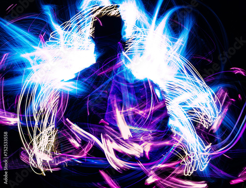 Human silhouettes between lights. Light painting in the dark.