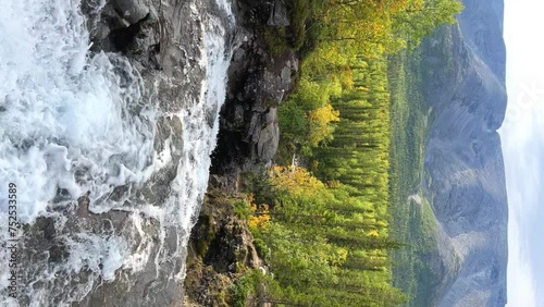 A beautiful waterfall in the autumn mountains beyond the Arctic Circle in the north, in Khibiny, Murmansk region. Panoramic view of a beautiful waterfall in the mountains in autumn, Kola Peninsula 4К photo