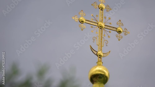 Focus transition: cross on Cathedral of Assumption of Blessed Virgin Mary is an Orthodox church. Temple is located in ancient Russian fortress of Kremlin, Dmitrov, Moscow region, Russia.