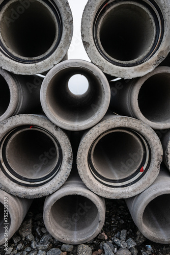 Large pile of concrete drain pipes at a construction site. © Trygve