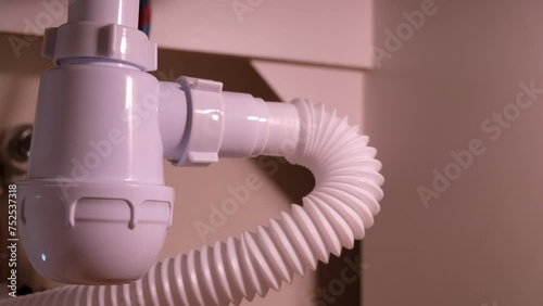 Repairing plumbing pipes under the kitchen sink