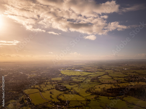 A high wide drone aerial view of Cheltenham and Gloucestershire in England at sunset