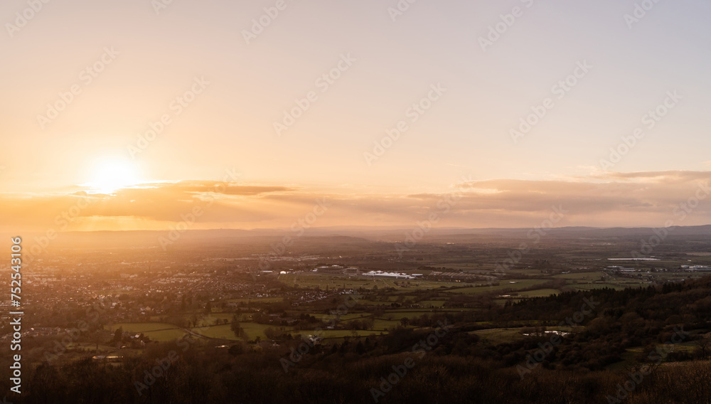 A sunset aerial view of Cheltenham and the Gloucestershire countryside, with distant fields, racecourse and farms