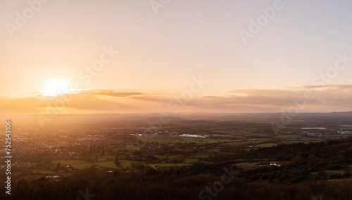 A sunset aerial view of Cheltenham and the Gloucestershire countryside, with distant fields, racecourse and farms © UAV4