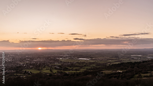 A sunset aerial view of Cheltenham and the Gloucestershire countryside, with distant fields, racecourse and farms