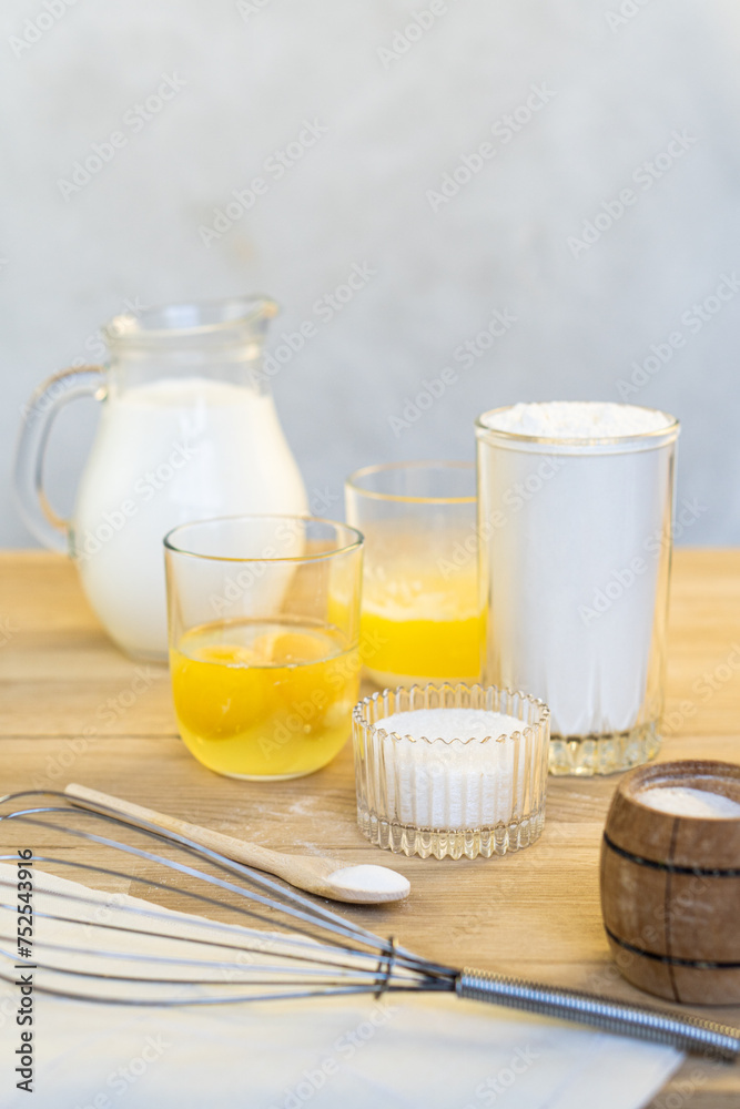Products for making pancakes. Milk, eggs, butter, flour, sugar and salt.