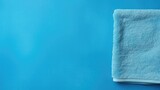 Blue cotton towels on a blue background. Bathroom decor and accessories.