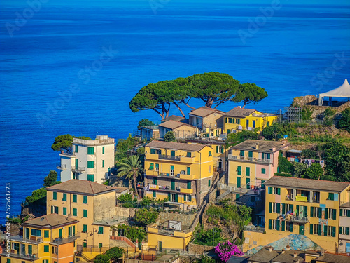 Aerial panoramic view of Riomaggiore town with many colorful houses and bay with small boats in Cinque Terre in an early morning photo