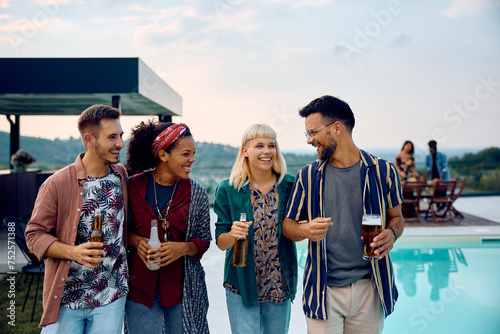 Multiracial group of happy friend having fun while gathering at pool party. © Drazen