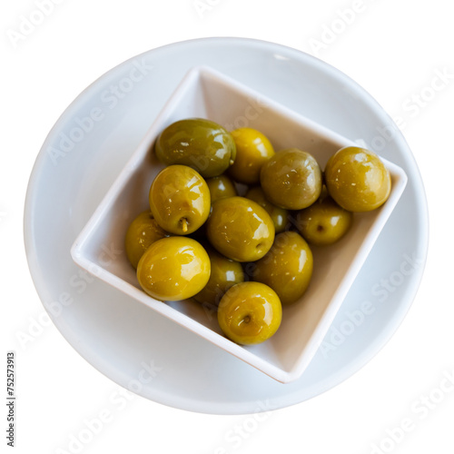 Large green olives with pits served to table in bowl. Isolated over white background