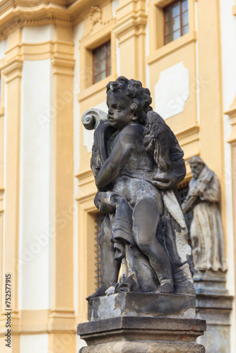 Baroque statue before facade Loreta Monastery in Prague, Czech Republic