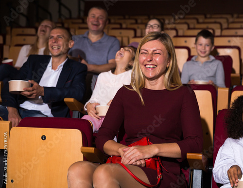 caucasian woman laughting at premiere in theatrical hall photo