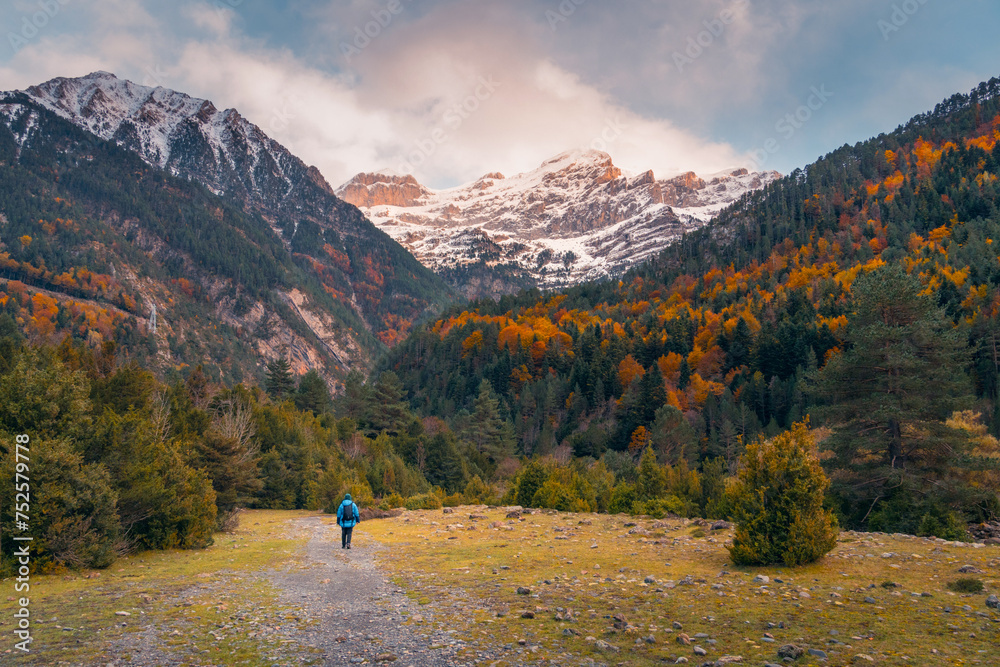 Hiker in autumnal Bujaruelo Valley, Pyrenees Hiker in autumnal Bujaruelo Valley, Pyrenees