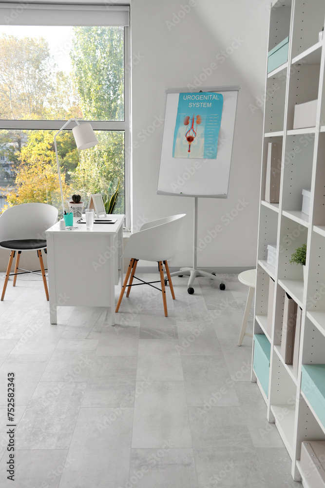 Fototapeta premium Interior of light medical office with workplace and flipchart