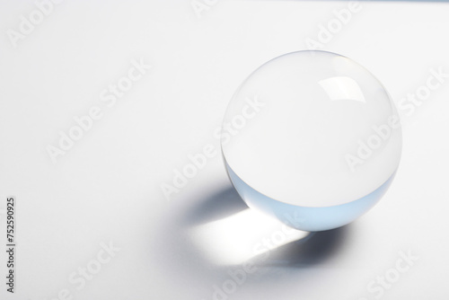 Transparent glass ball on white background. Space for text