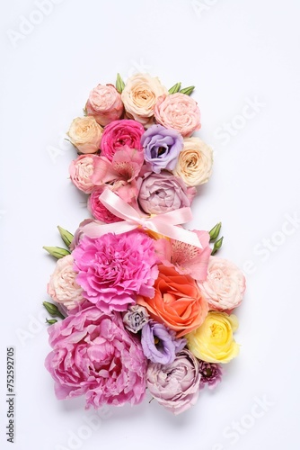 8 March greeting card design made with beautiful flowers on white background, top view