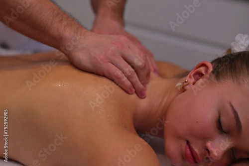 Body care. Spa body massage treatment. Woman having massage in spa salon
