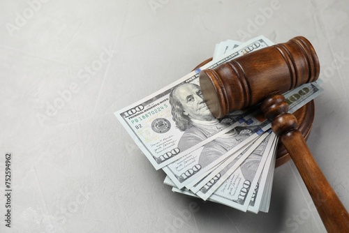 Judge's gavel and money on grey table. Space for text