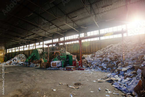 Pressing and packing of wastepaper in recycling factory photo