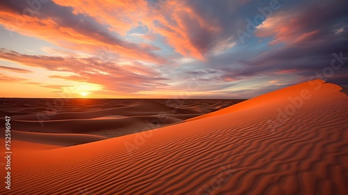 Sunset over sand dunes. Panoramic view of the desert.