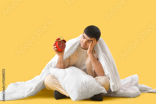 Young man with alarm clock,...