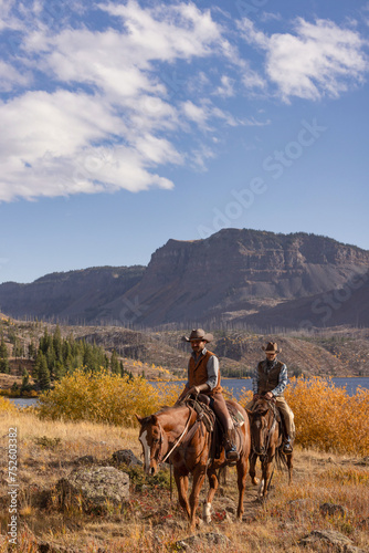 Photography Cowboys riding horses in mountain wilderness outfitter