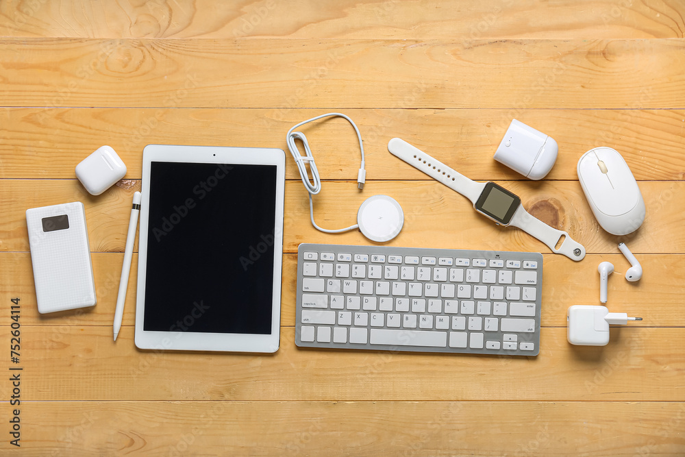 Composition with different modern gadgets on wooden background Composition with different modern gadgets on wooden background