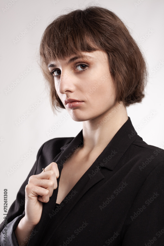 studio portrait of a beautiful girl with short hair wearing business casual outfit. studio portrait of a beautiful girl with short hair wearing business casual outfit.