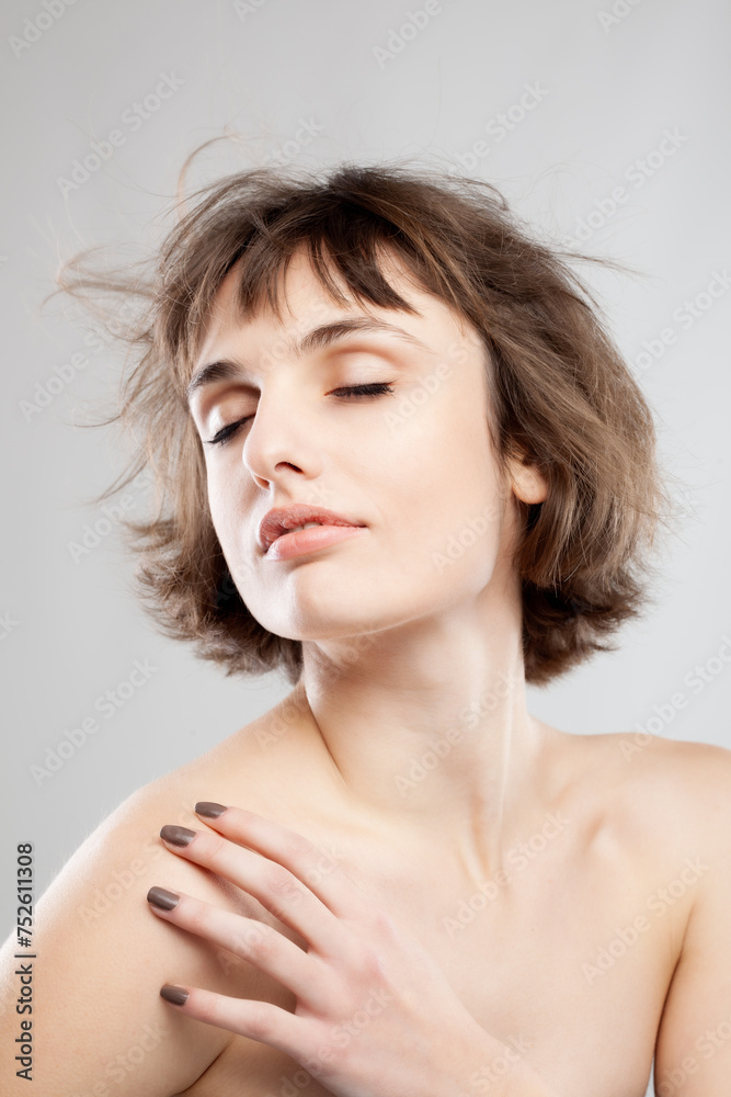 studio portrait of a beautiful brunette girl with short hair in the air studio portrait of a beautiful brunette girl with short hair in the air