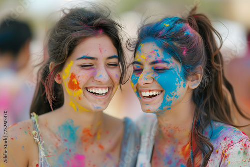 Holi festival. Happy friends with faces smeared in Holi colors, laughing and enjoying the vibrant, festive atmosphere together.