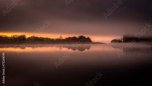 Peaceful sunrise with a delicate misty atmosphere over a mirrored body of water, Rhine Main Danube RMD Canal Bamberg photo