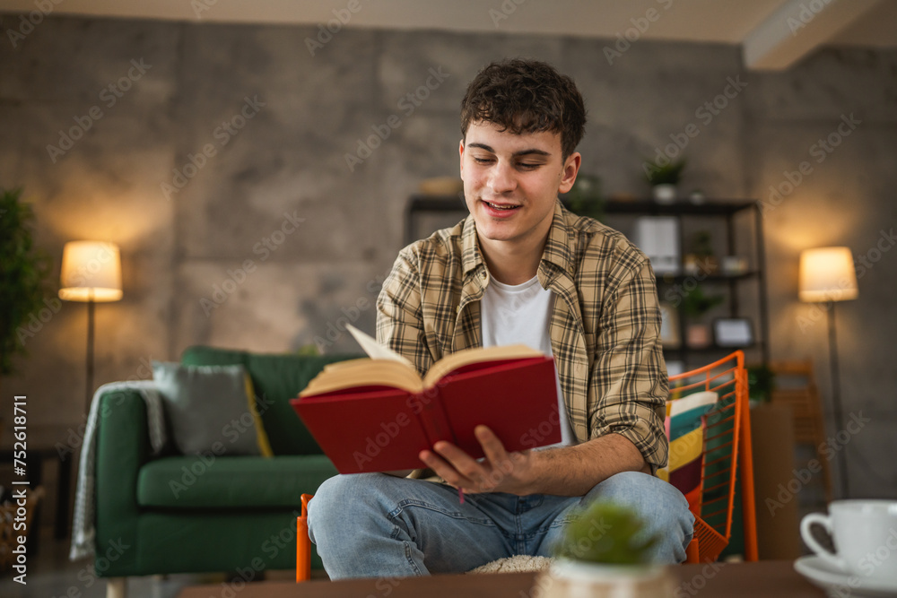 Young man caucasian teenager read book study at home education concept Young man caucasian teenager read book study at home education concept