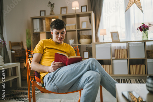 Young man caucasian teenager read book study at home education concept