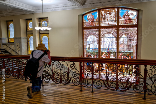 Photography Photographer taking photo of the building interior with stained glass