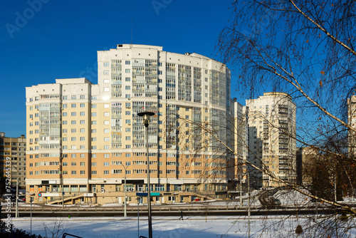 Walking area in residential sleepy district of capital of Belarus - Minsk. Sunny winter morning in Malinovka urban area photo