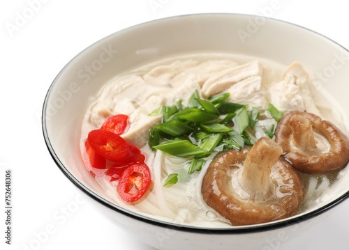 Delicious ramen with meat and mushrooms in bowl isolated on white. Noodle soup