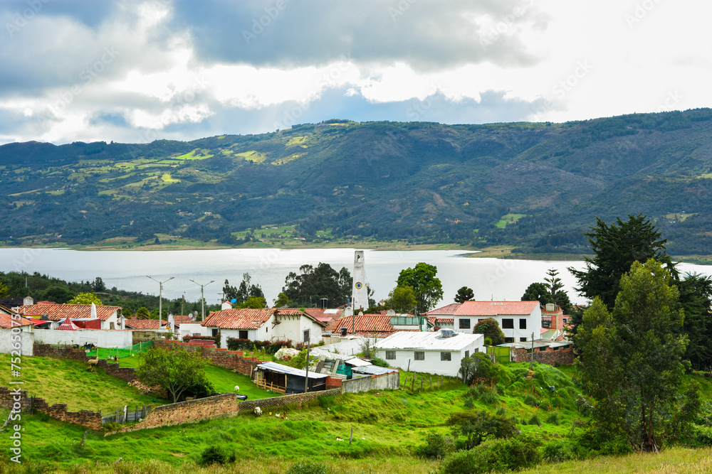 Scenic view of Guatavita, Colombia. Traditional architecture amidst lush greenery, with mountains and lake in the backdrop