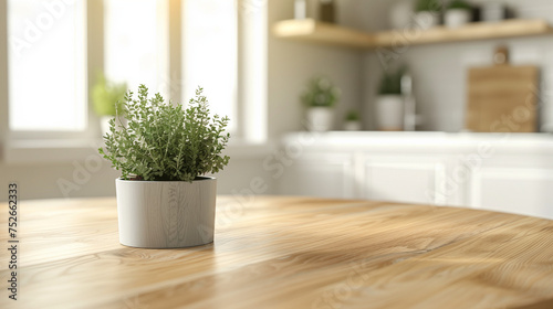 An empty wooden table that has been used as a product photo template, with a mini potted plant on top. The table is located in the middle of a minimalist kitchen space, with a clean and simple backgro © mohammad