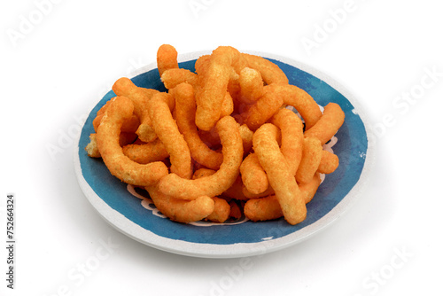 A blue plate of orange cheese corn puffs isolated on white