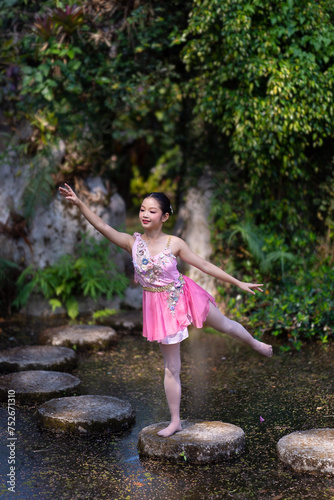 A girl beautiful ballerina dancing outdoors in a park. Ballerina Project